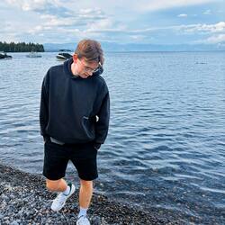 Joscha standing on a rocky lakeshore