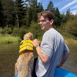 Joscha paddleboarding with a dog